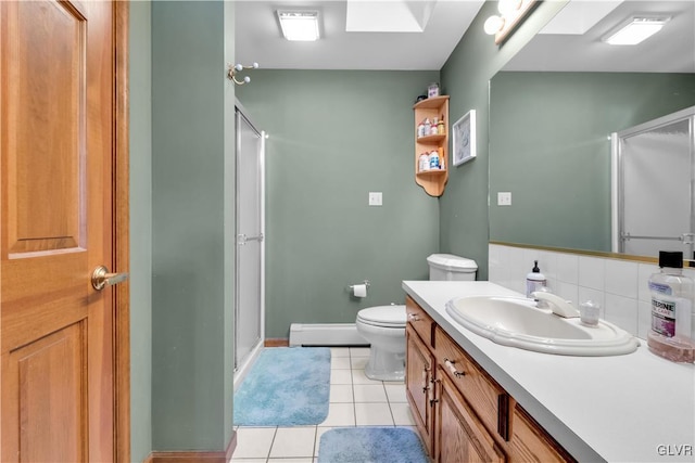 full bath with tile patterned flooring, vanity, baseboard heating, backsplash, and a shower stall