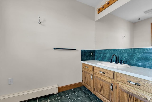 bathroom with tile patterned flooring, visible vents, vanity, baseboards, and baseboard heating