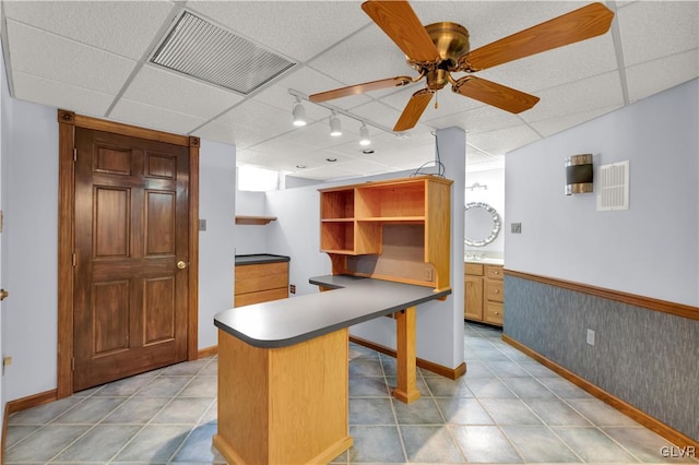 kitchen featuring light tile patterned floors, a drop ceiling, visible vents, a ceiling fan, and open shelves