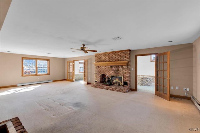 unfurnished living room with light carpet, visible vents, baseboards, baseboard heating, and a brick fireplace