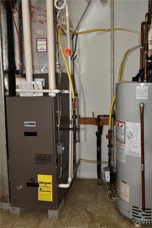 utility room with gas water heater and heating unit