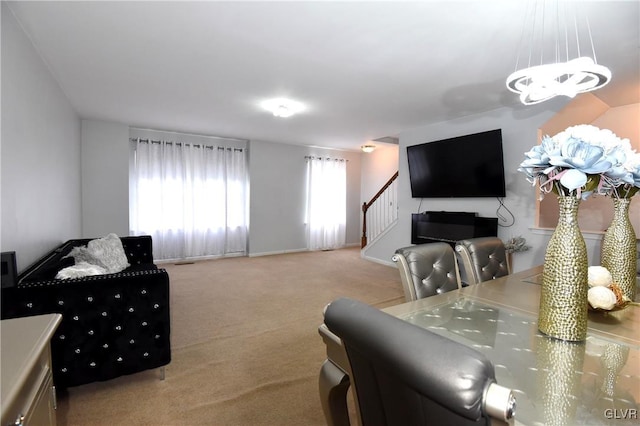 living area featuring carpet floors, stairway, and baseboards