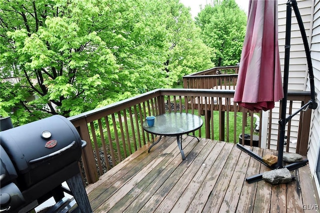 wooden terrace featuring a grill