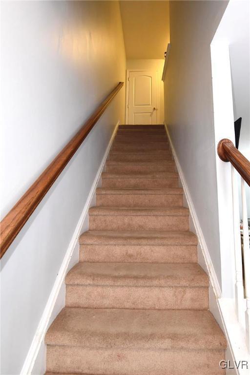 stairway featuring baseboards