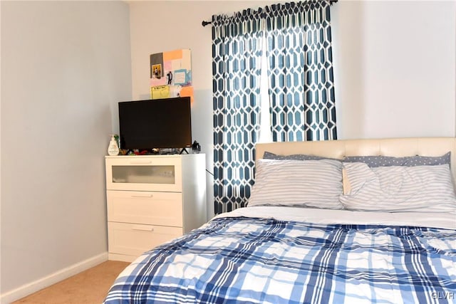 bedroom featuring carpet flooring and baseboards