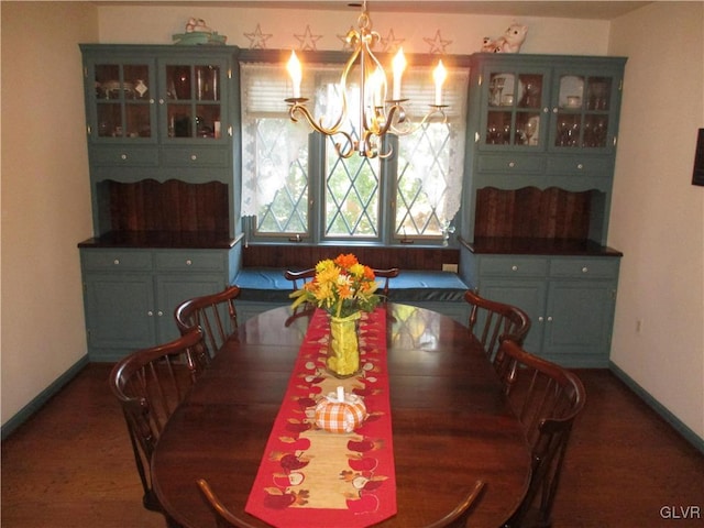 dining room with a chandelier and baseboards