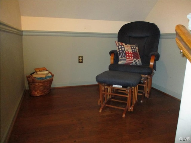 living area featuring lofted ceiling, baseboards, and wood finished floors