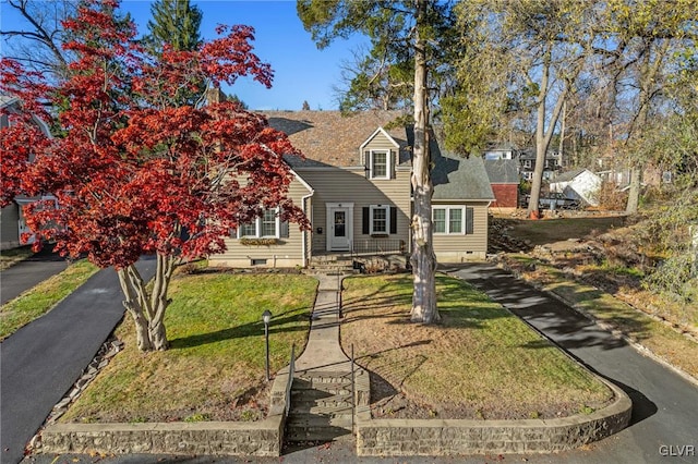 view of front of home with crawl space, a front lawn, and roof with shingles