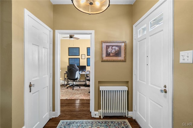 entryway with a baseboard radiator, radiator heating unit, baseboards, and dark wood-style flooring