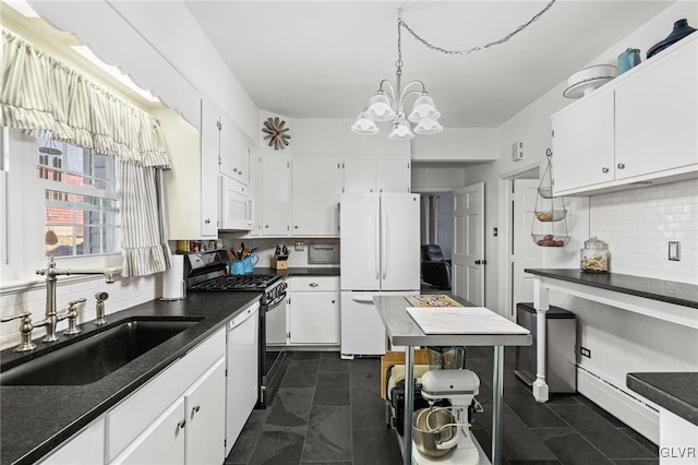 kitchen featuring backsplash, white cabinetry, a sink, a chandelier, and white appliances