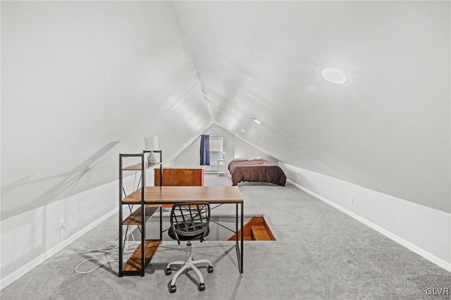 carpeted home office with lofted ceiling and baseboards