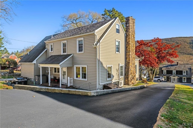 view of front of home featuring a patio area and a chimney