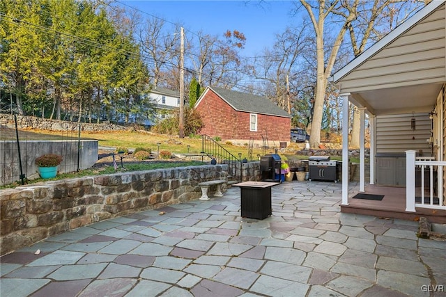 view of patio with fence and area for grilling