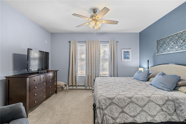 bedroom with a baseboard heating unit, light colored carpet, and ceiling fan