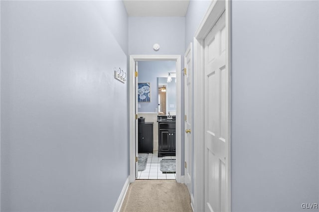 hallway with light colored carpet