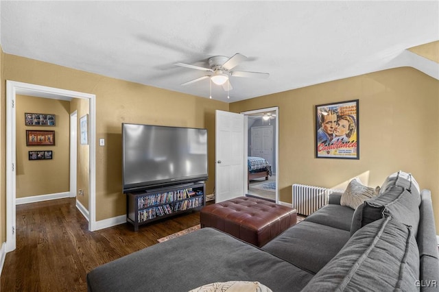 living area featuring radiator heating unit, ceiling fan, baseboards, and wood finished floors