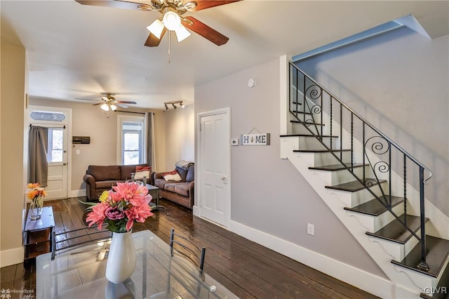 living room with stairs, baseboards, dark wood finished floors, and a ceiling fan