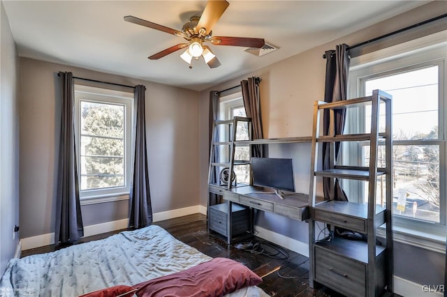 bedroom with baseboards, visible vents, and dark wood-type flooring