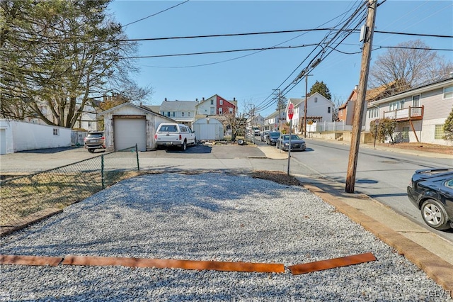 view of road with a residential view, curbs, and sidewalks