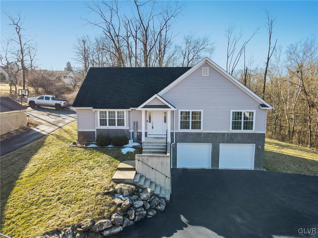 3150 Wilson Ave, Bethlehem Twp, PA 18020 - view of front facade with aphalt driveway, a front lawn, and an attached garage