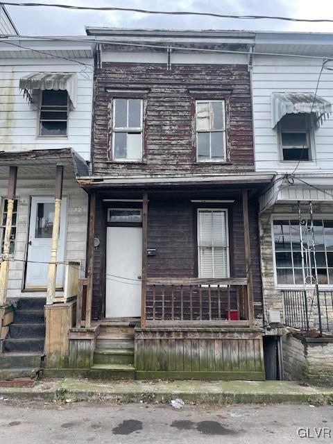 view of property featuring entry steps and a porch