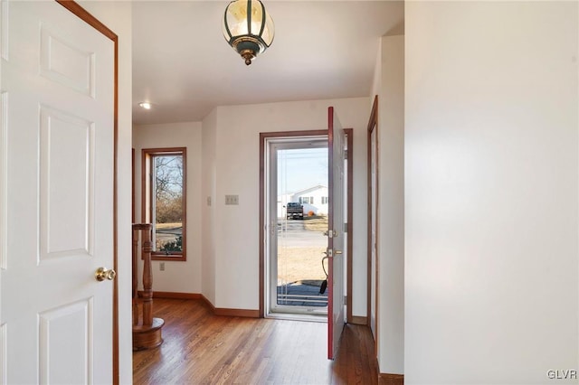 entryway featuring baseboards and wood finished floors