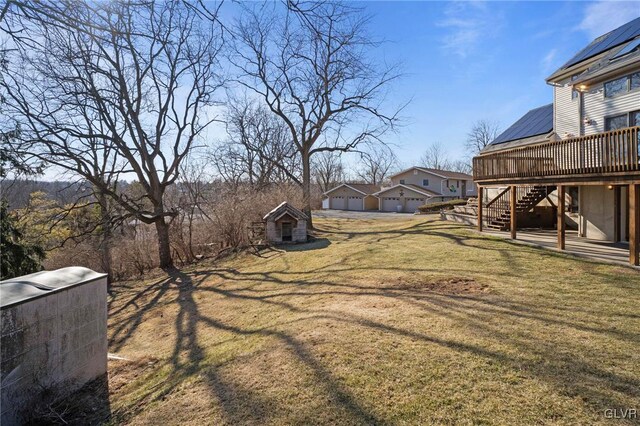 view of yard with stairs, an outbuilding, and a wooden deck