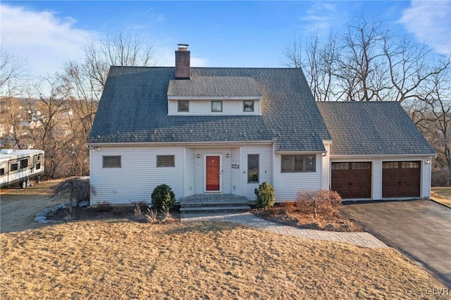 view of front of home with aphalt driveway, a shingled roof, a chimney, and an attached garage