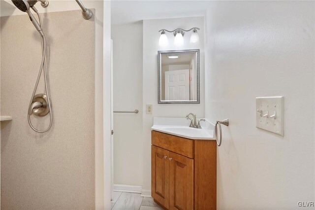 bathroom with vanity and walk in shower