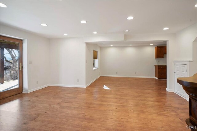 unfurnished living room featuring light wood finished floors, baseboards, and recessed lighting