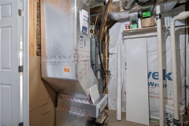 utility room featuring heating unit