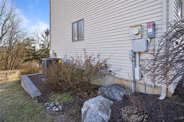 view of side of property with central air condition unit