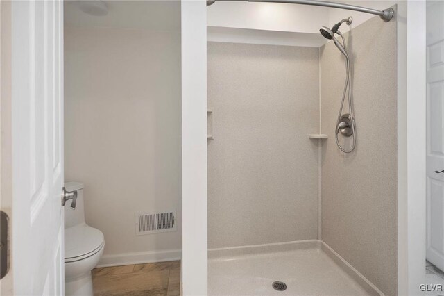 full bath featuring a stall shower, visible vents, and toilet