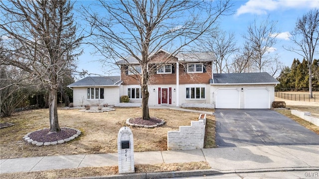 view of front of property with driveway, brick siding, and an attached garage