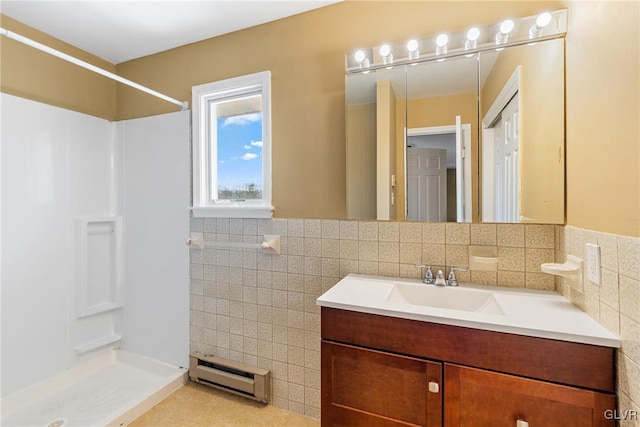 full bath featuring a baseboard heating unit, tile walls, vanity, and a walk in shower