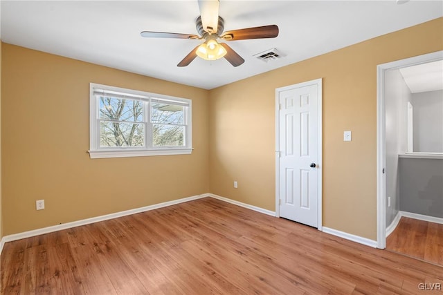 unfurnished bedroom with light wood-style floors, baseboards, visible vents, and a ceiling fan