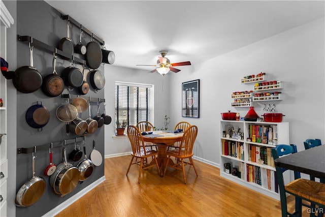 dining room with ceiling fan, baseboards, and wood finished floors