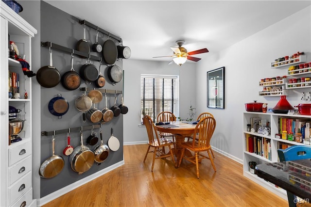 dining area with ceiling fan, wood finished floors, and baseboards