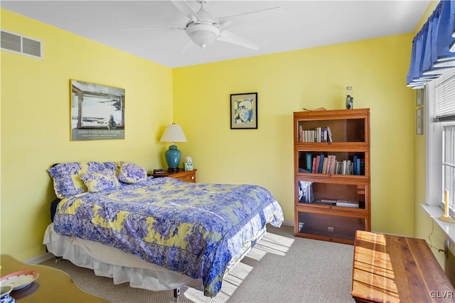 bedroom featuring ceiling fan, carpet flooring, and visible vents