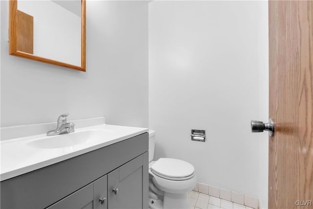 bathroom featuring toilet, tile patterned flooring, and vanity