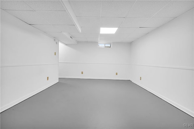 below grade area featuring a drop ceiling and baseboards