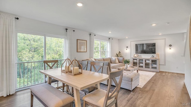 living room with baseboards, light wood-style flooring, and recessed lighting