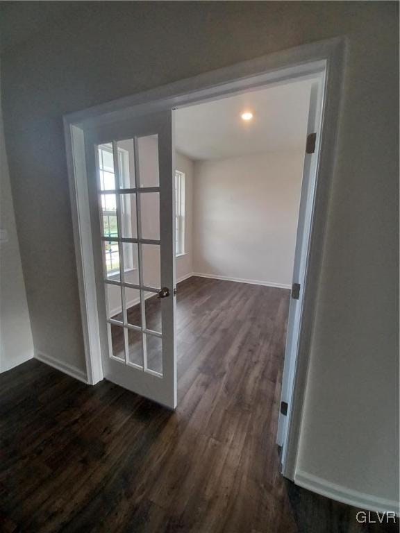 interior space with dark wood finished floors and baseboards