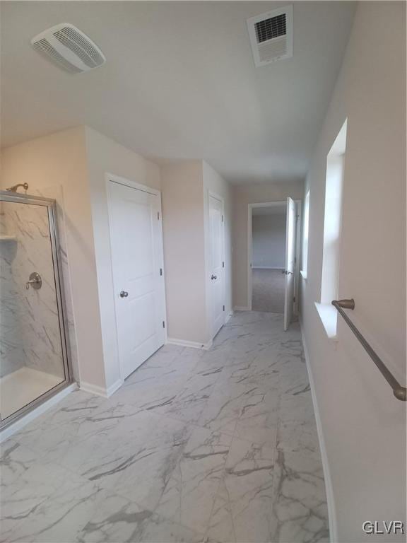 hall featuring marble finish floor, visible vents, and baseboards