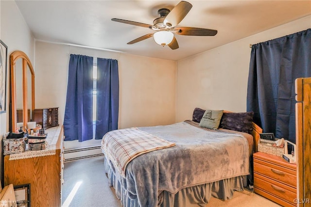 carpeted bedroom featuring a baseboard heating unit and a ceiling fan