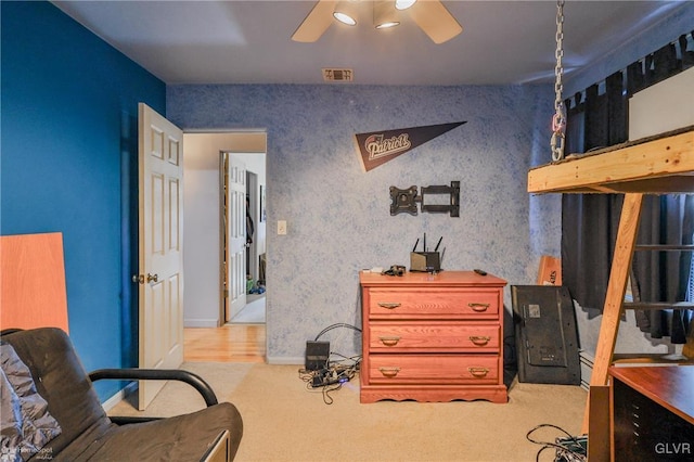 bedroom featuring carpet flooring, visible vents, and wallpapered walls