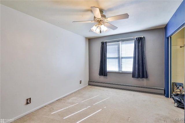 spare room with carpet floors, ceiling fan, a baseboard heating unit, and baseboards