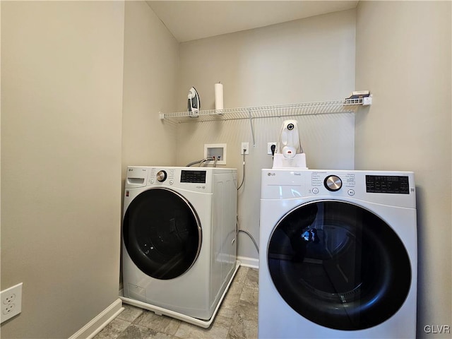 laundry area featuring laundry area, baseboards, and separate washer and dryer