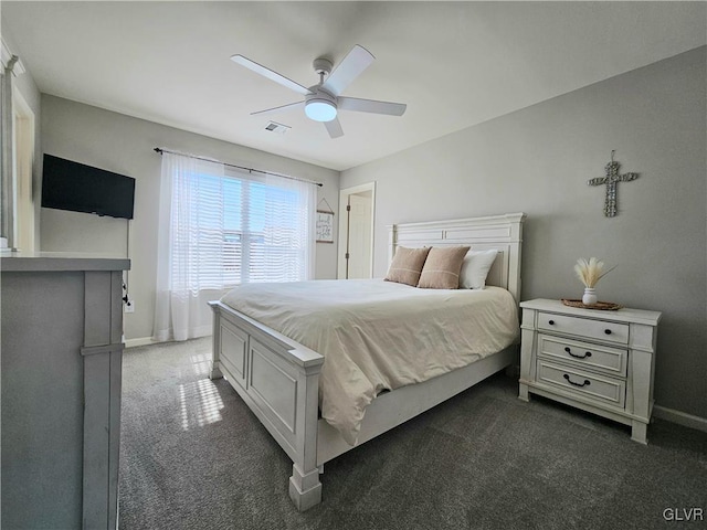 bedroom featuring baseboards, visible vents, dark carpet, and ceiling fan