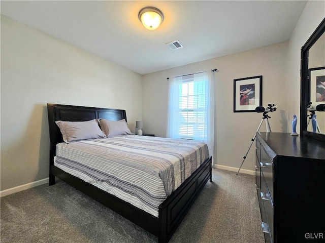 bedroom featuring visible vents, dark carpet, and baseboards